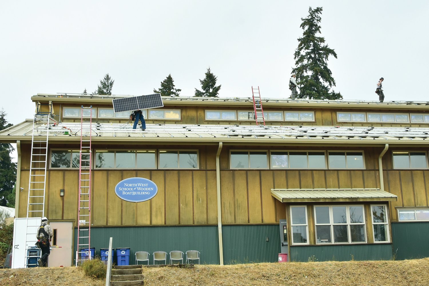 Workers set up solar panels at the Northwest School of Wooden Boatbuilding in Port Hadlock. The project was finished in November.